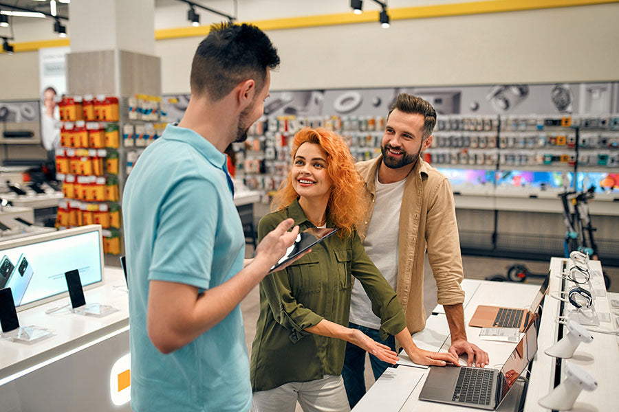 Customer selling mixed electronics collection during in-store visit at PayMore Buford